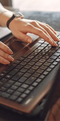 Person Typing on a keyboard looking for eLearning courses